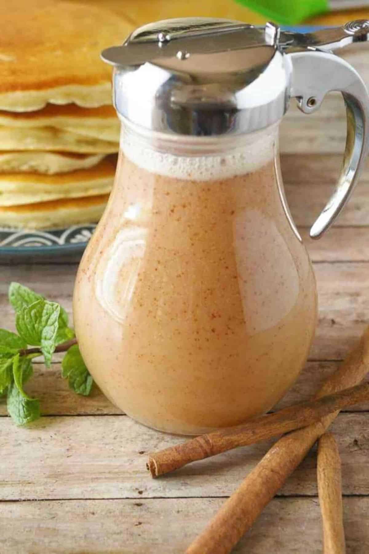 Cinnamon Cream Syrup in a glass pitcher.