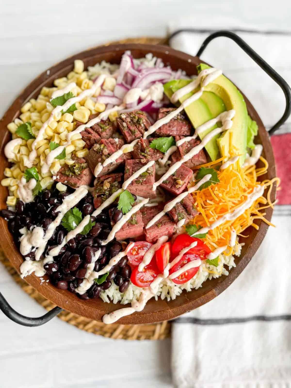 Cilantro Lime Steak Bowls in a wooden bowl.