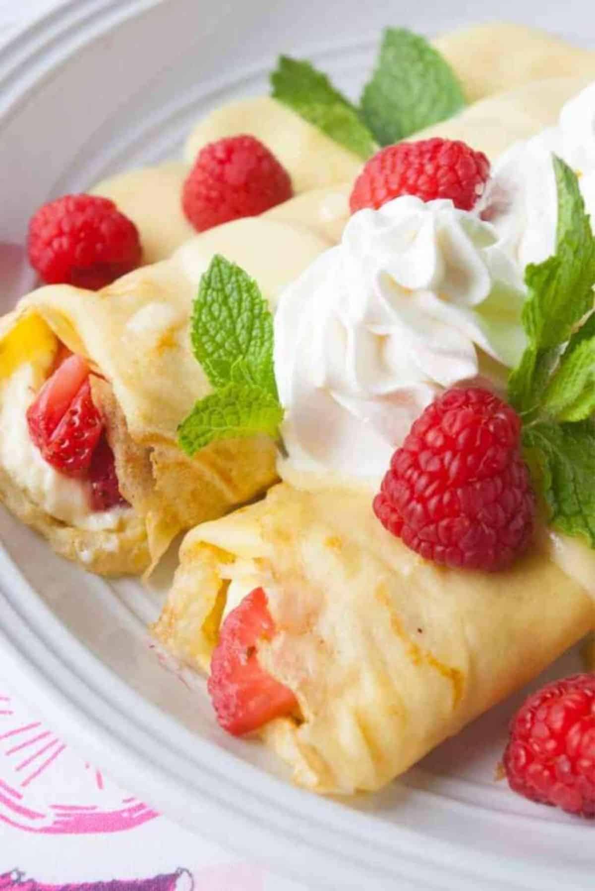 Sweet Berry Crepes with Cream Cheese Filling on a white plate.