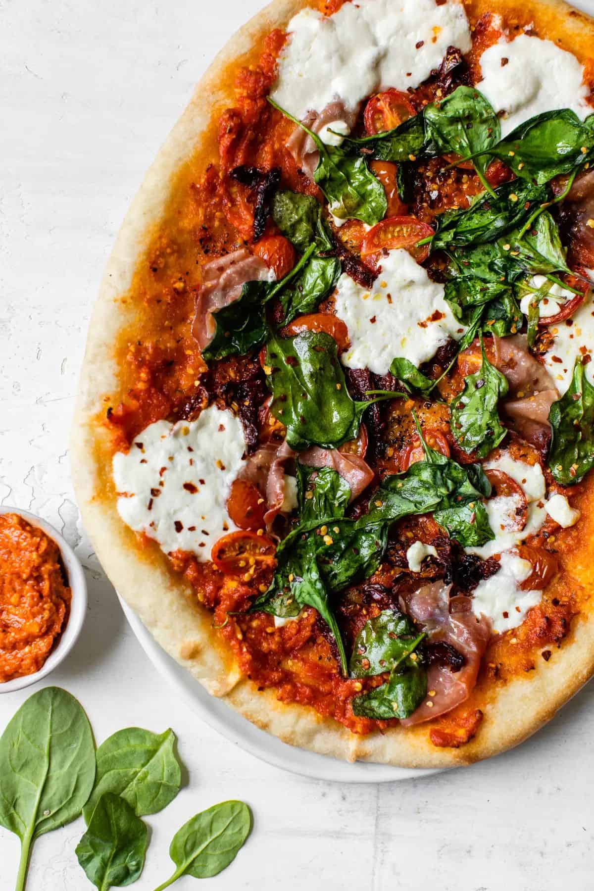 Delicious Sun-dried Tomato Pizza on a white tray.