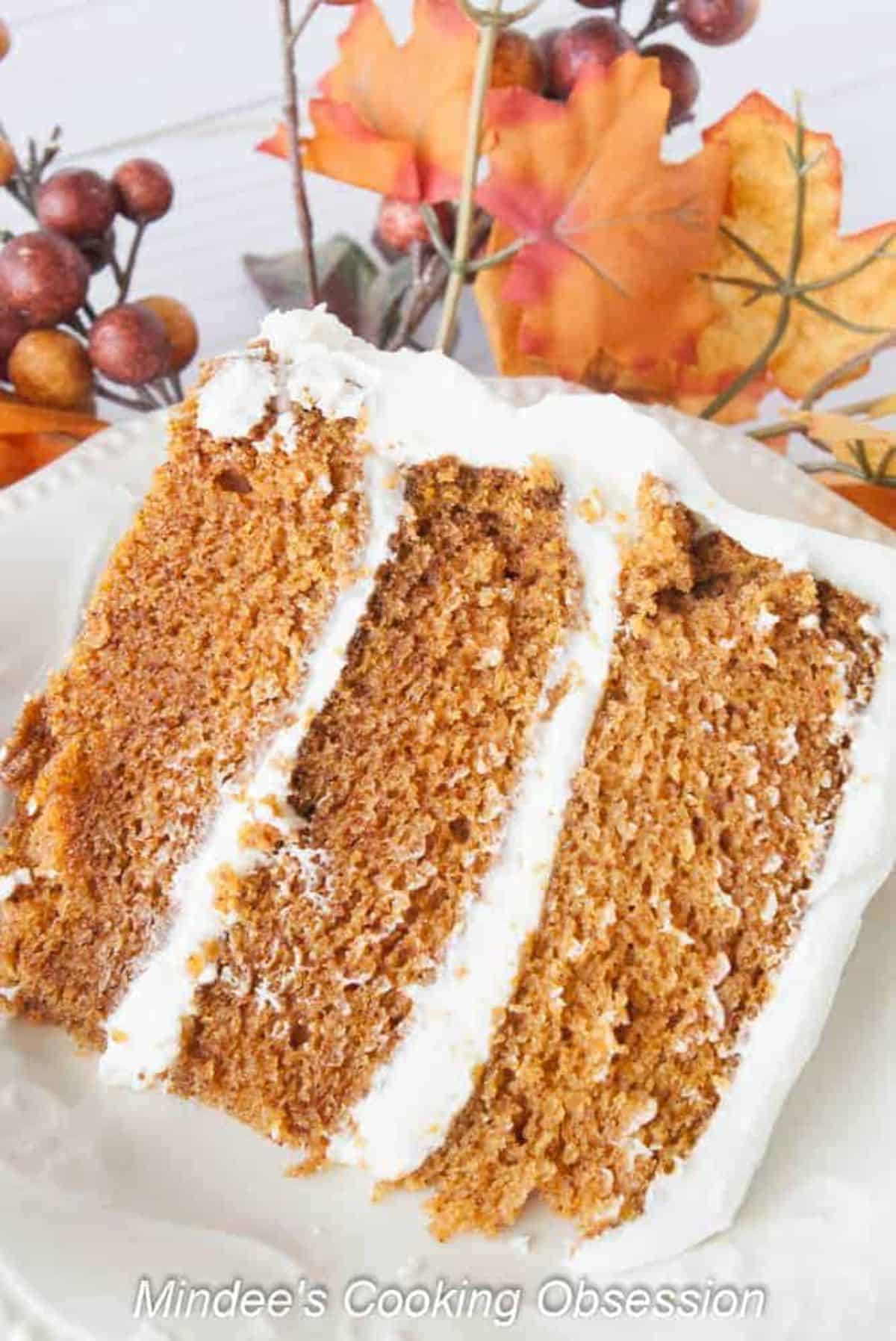 A piece of scrumptious Corrie's Triple Layer Carrot Cake on a white plate.