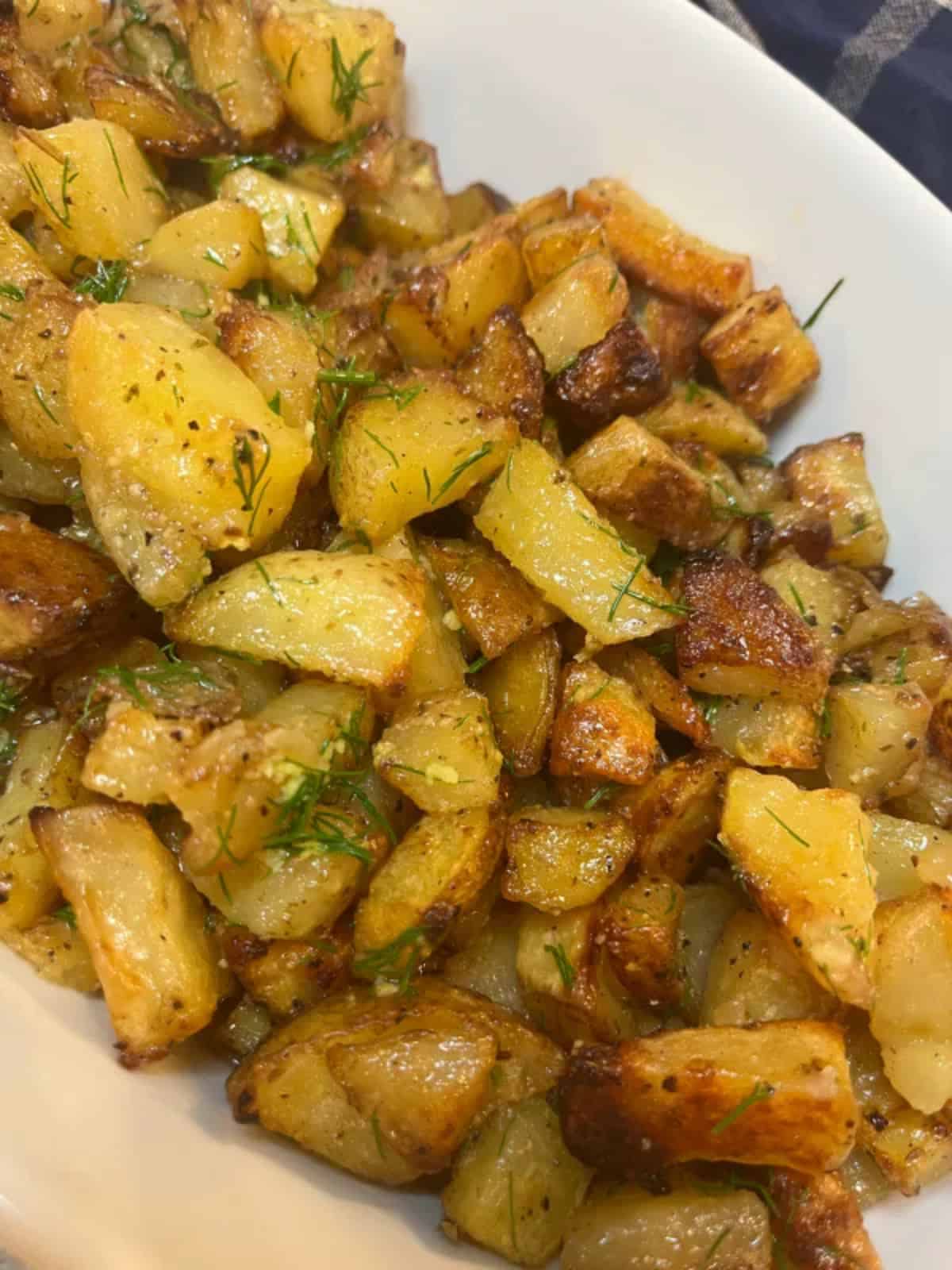 Dill and Lemon Roasted Potatoes in a white bowl.