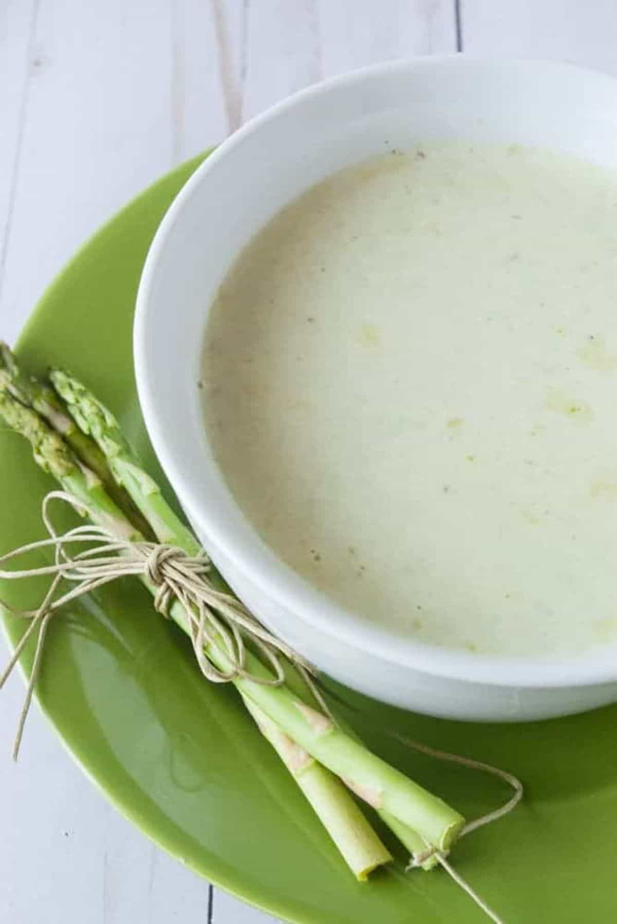 Healthy Cream of Asparagus Soup in a white bowl.