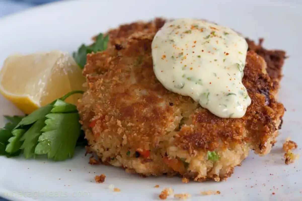 Crab Cake Sauce (Lemon Tarragon Mayonnaise) drizzled on a piece of crab cake.