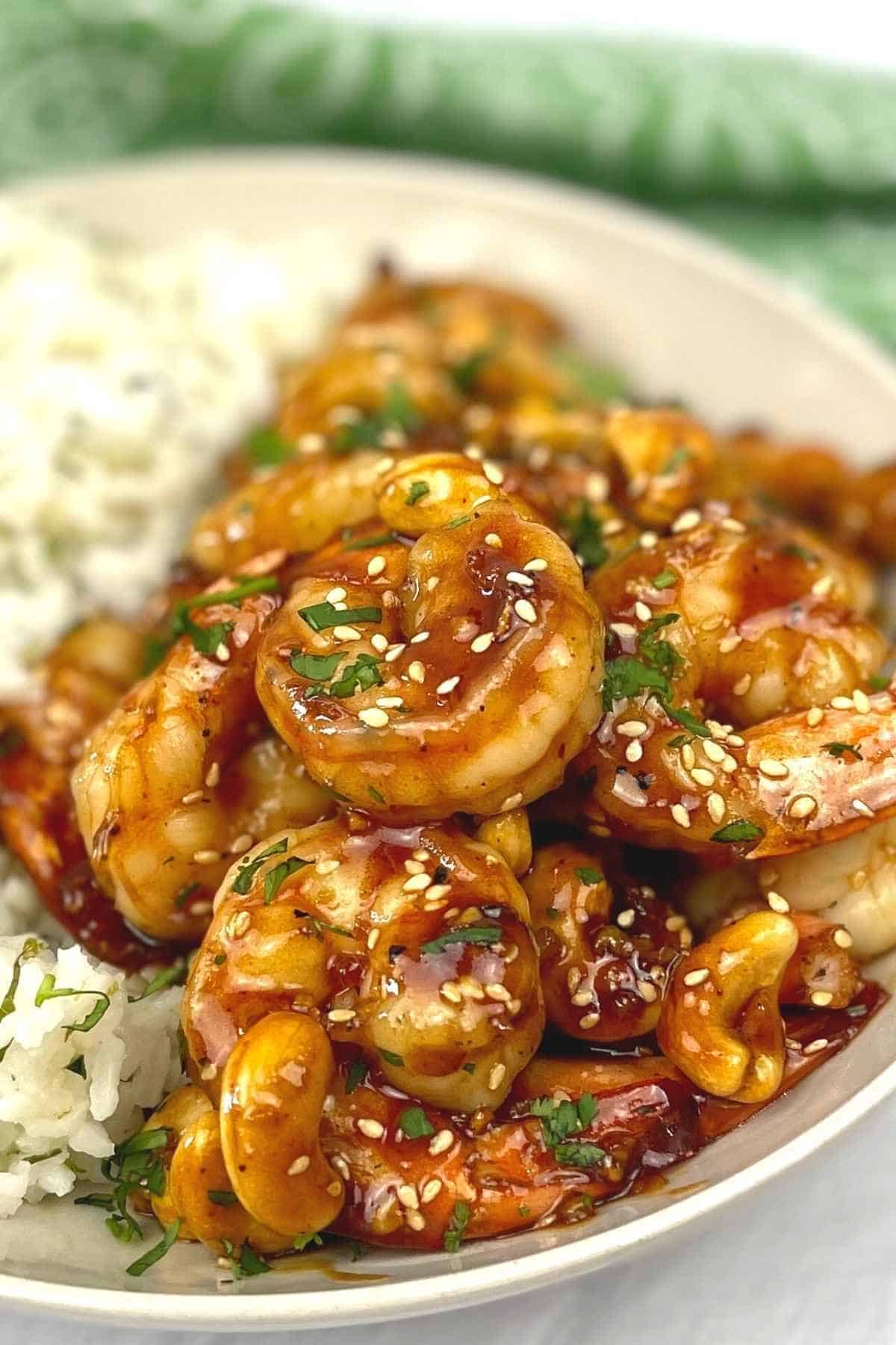 Cashew Shrimp Stir Fry with rice on a white bowl.