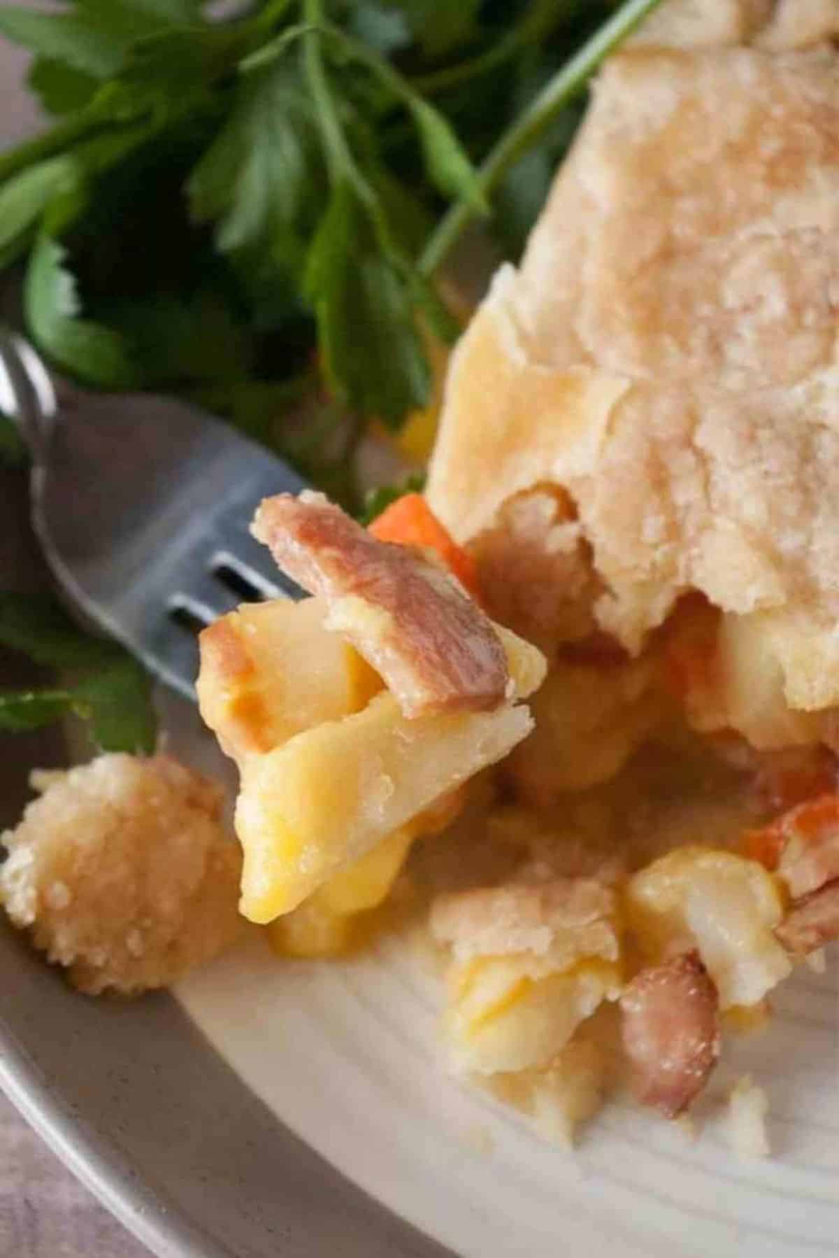 Ham and Cheese Pot Pie on a plate picked with a fork.