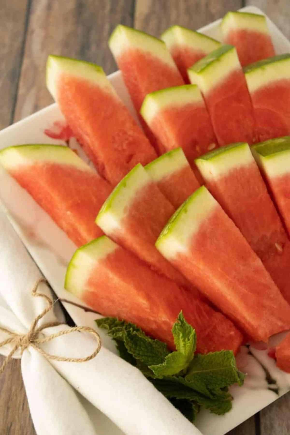 Easy Watermelon Sticks on a white plate.