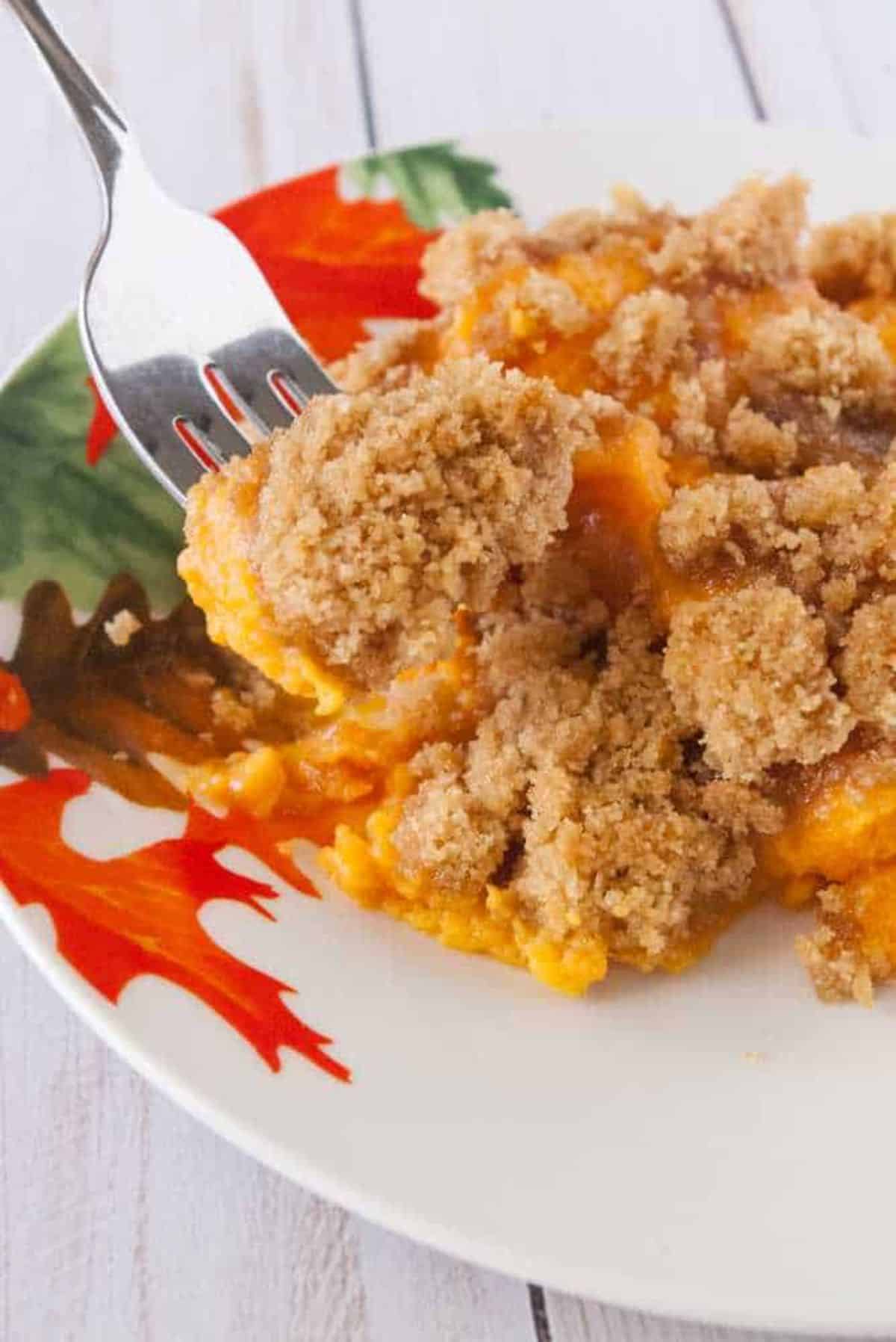 Delicious Streusel Topped Sweet Potatoes on a plate and on a fork.