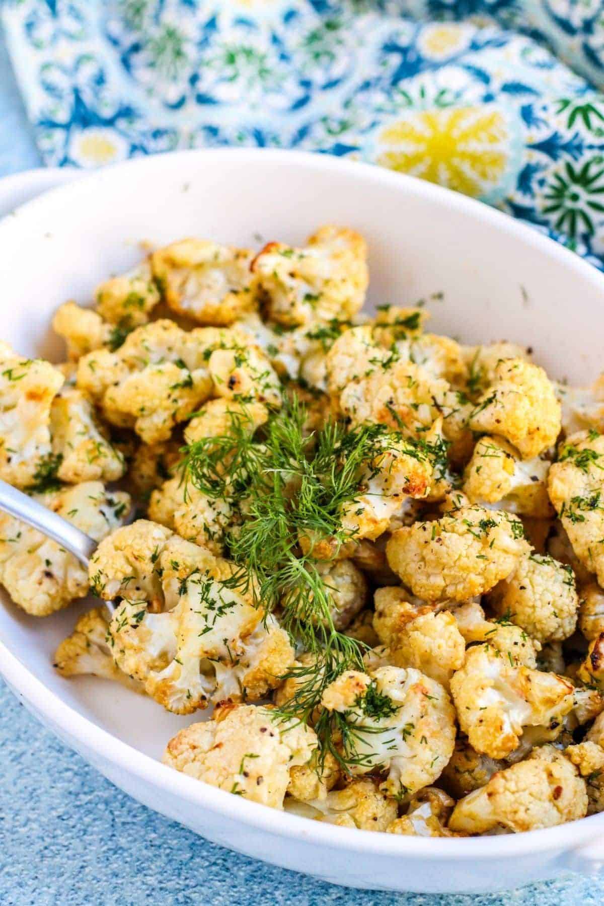 Dill and Garlic Roasted Cauliflower in a white bowl.