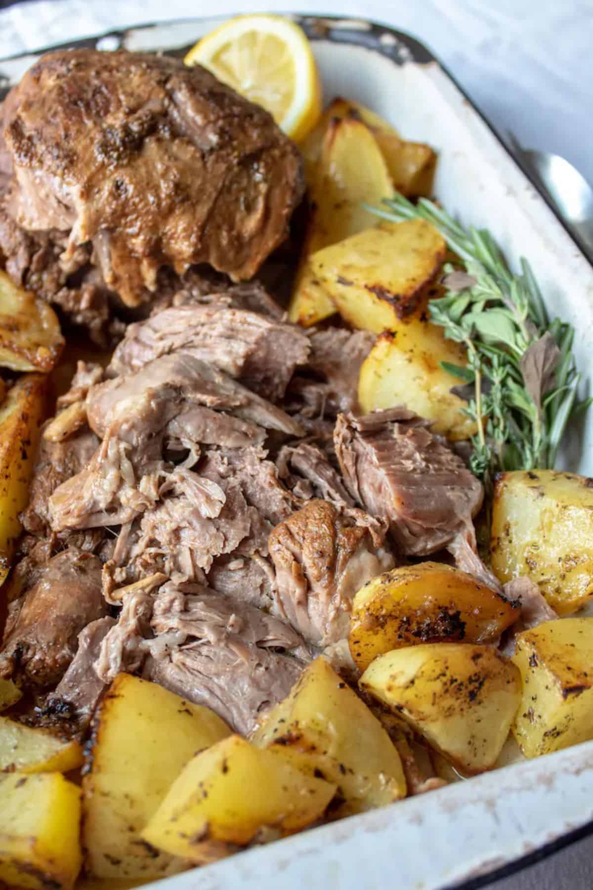 Greek Instant Pot Leg of Lamb in a white casserole.