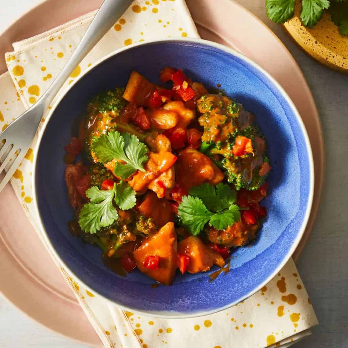 Massaman Curry With Turmeric Rice in a blue bowl.