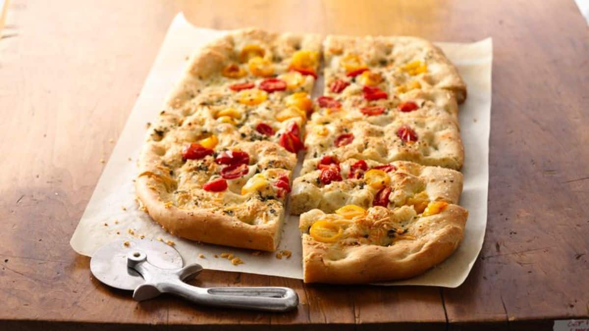 Focaccia Bread sliced on a table.