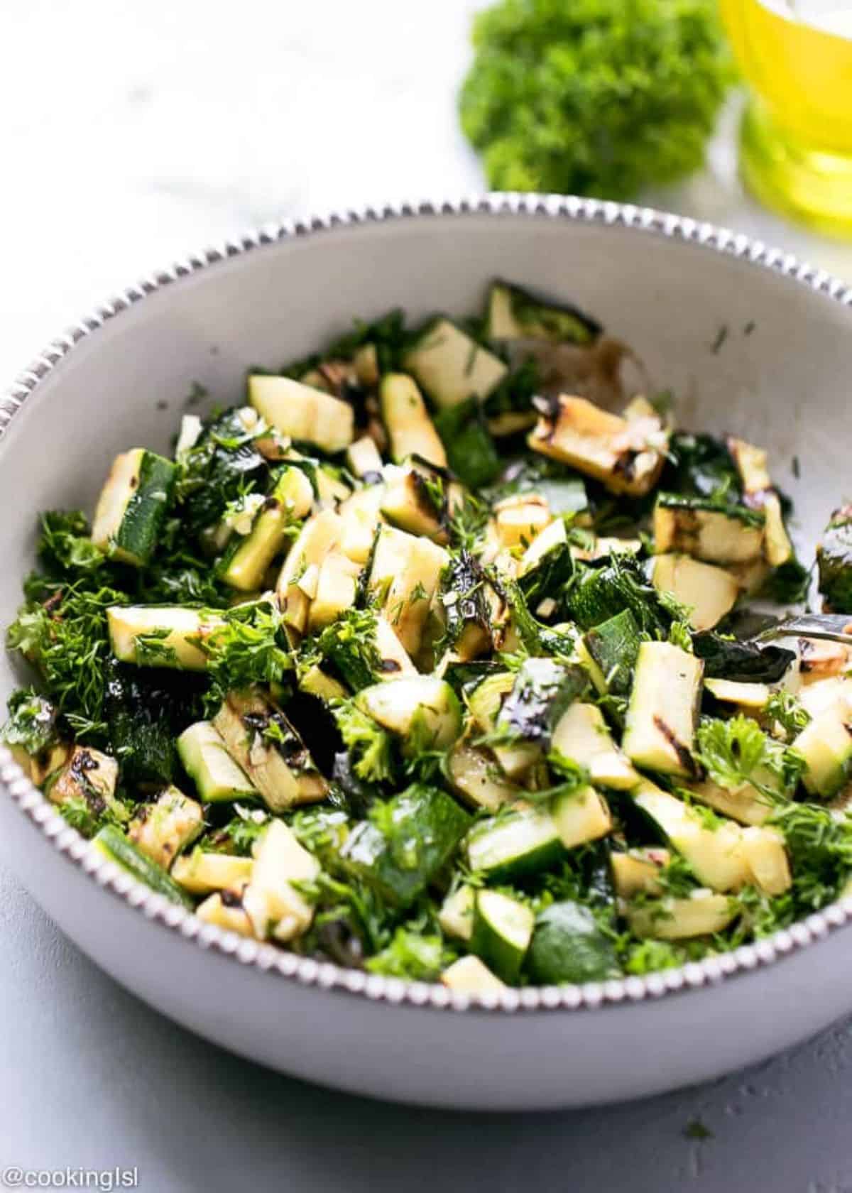 Grilled Zucchini Salad with Dill in a white-gray bowl.