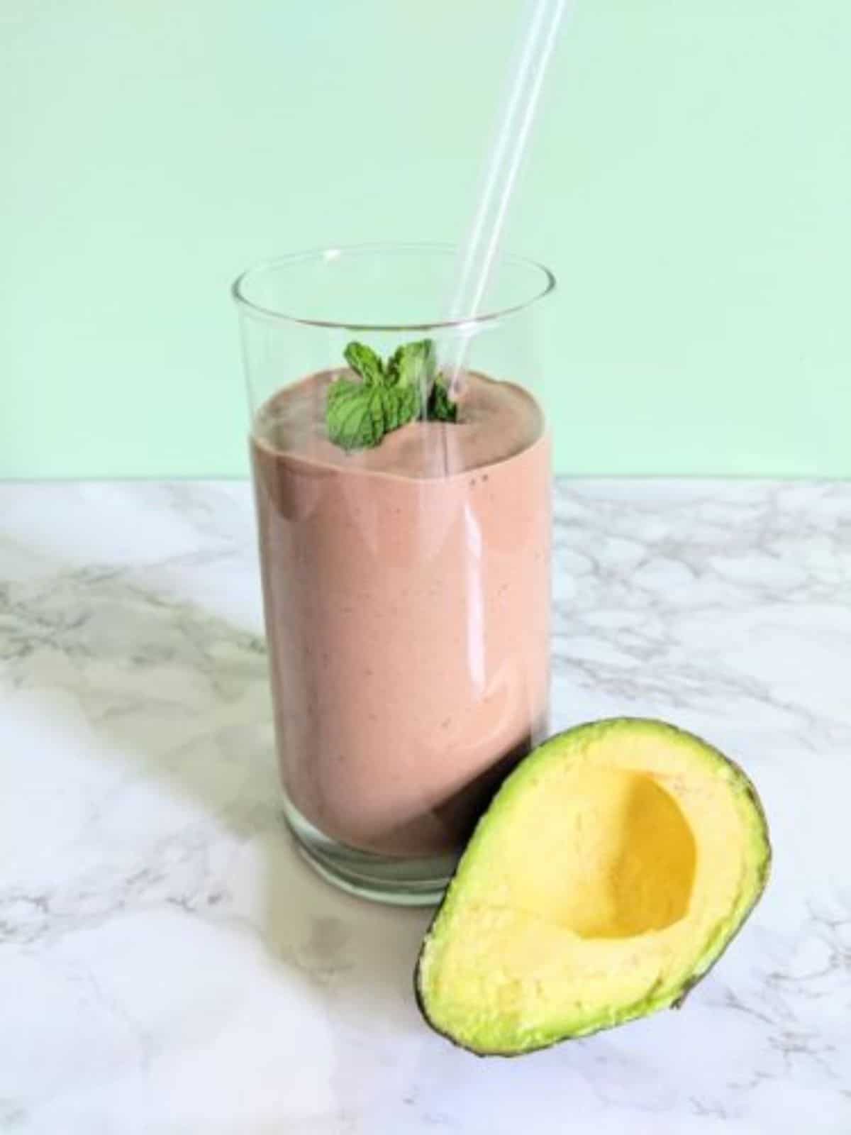 Healthy Mint Chocolate Smoothie in a glass cup with a straw.