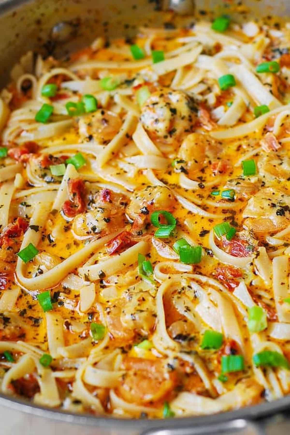 Garlic Shrimp Pasta with Spicy Sun-dried Tomato Cream Sauce in a skillet.