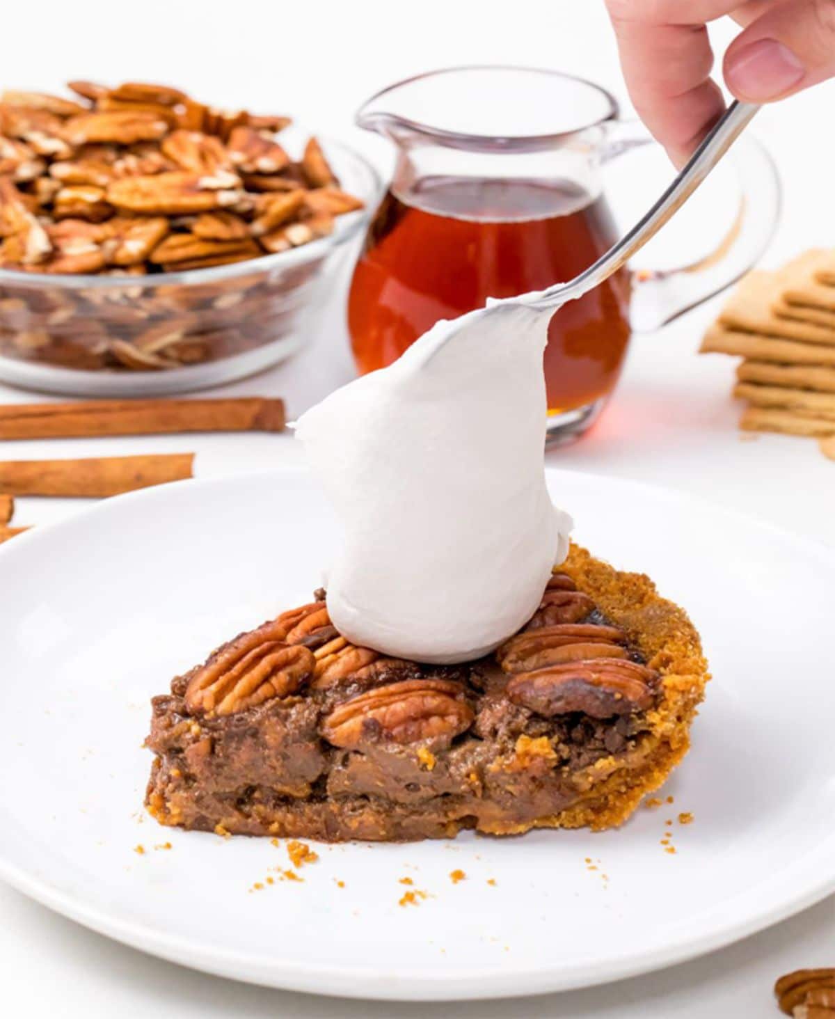 A piece of cake garnished with Coconut Whipped Cream.