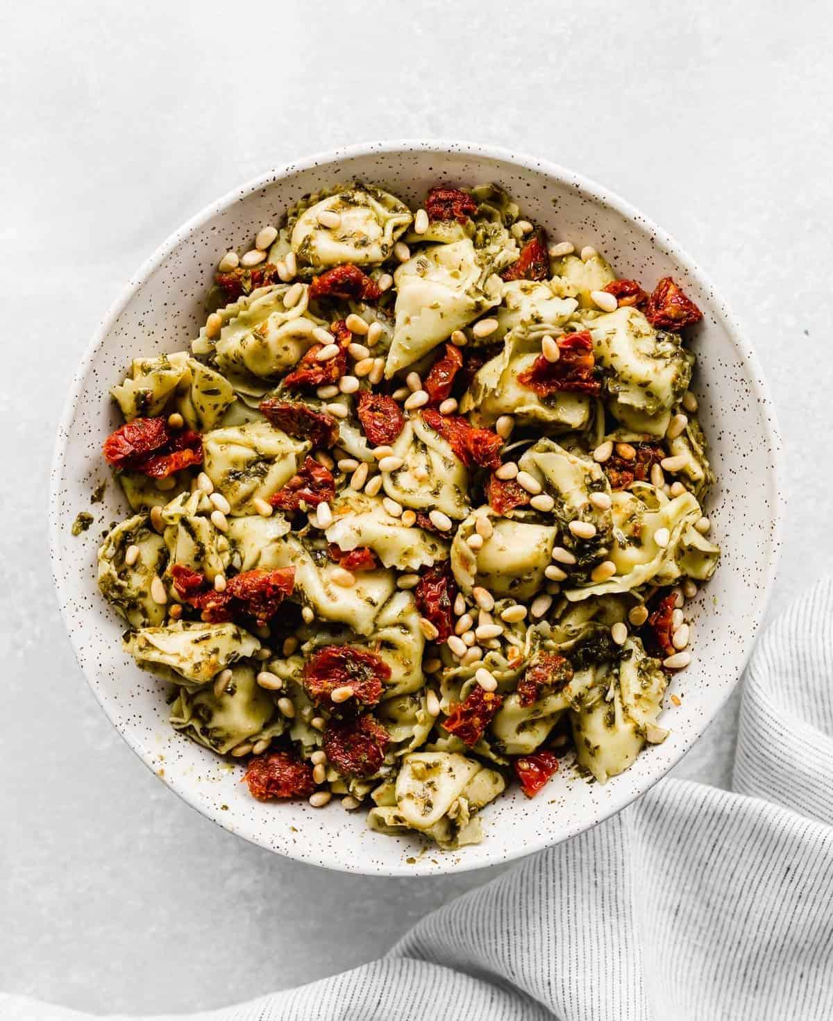 Delicious Pesto Tortellini Pasta in a white bowl.