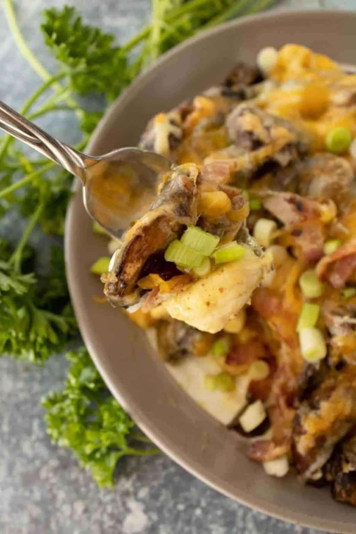 Tasty Honey Mustard Chicken with Bacon in a gray bowl and on a fork.