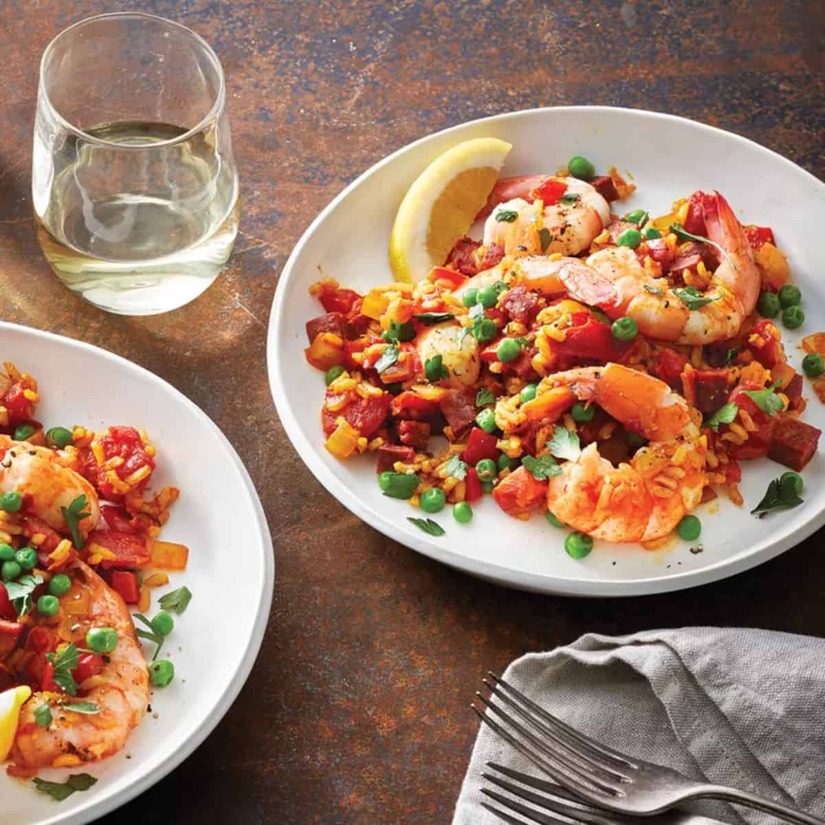Turmeric Shrimp and Chorizo Paella on two white plates.