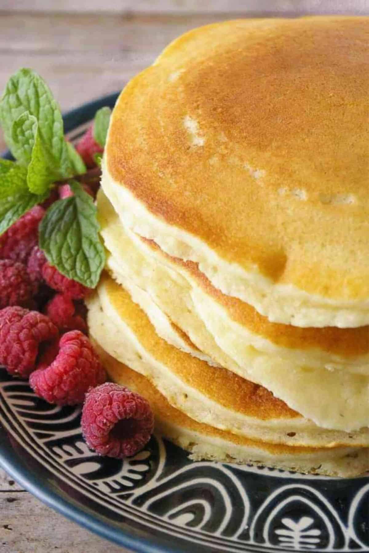 A stack of Fluffy Buttermilk Pancakes on a blue tray.