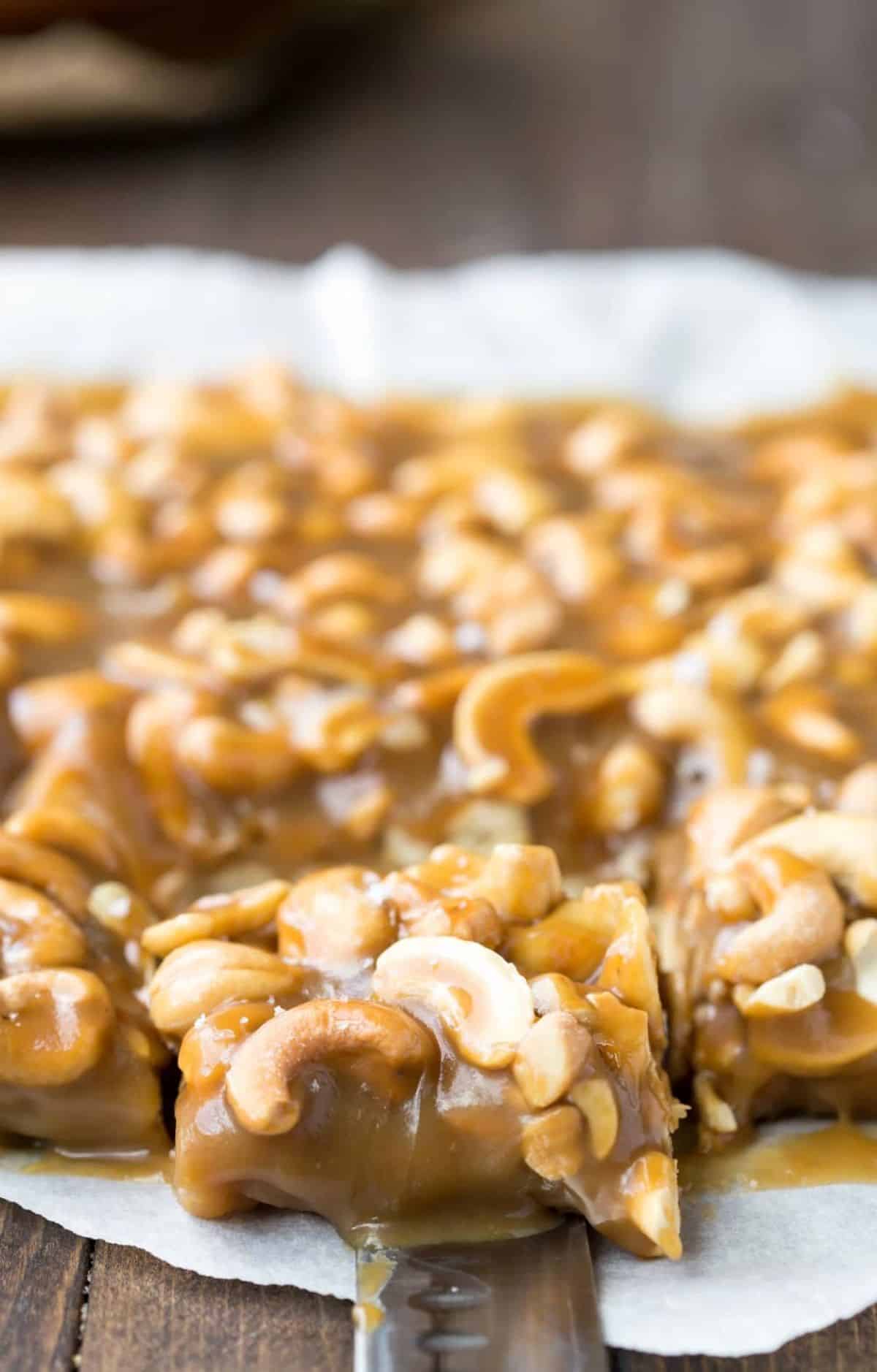 Salted Caramel Cashew Bars on a paper napkin.