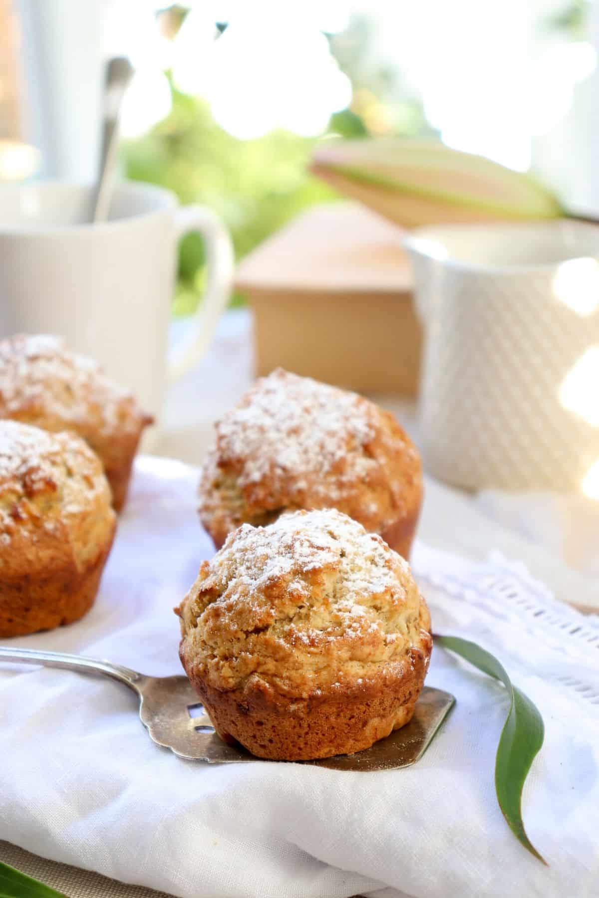 Delicious Banana Coconut Muffins on a table cloth.