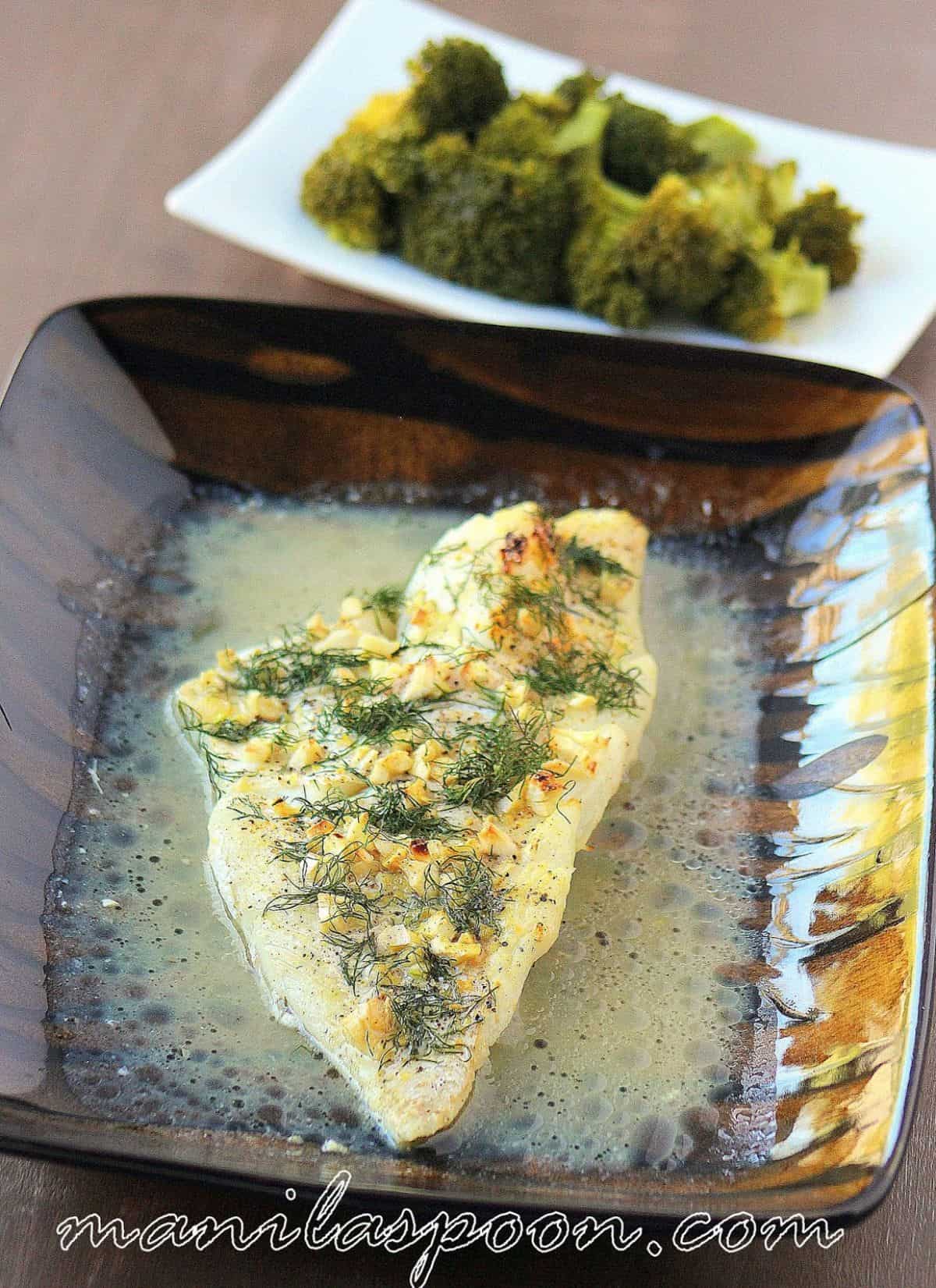 Dill and Lemon Baked Cod in a black fancy bowl.