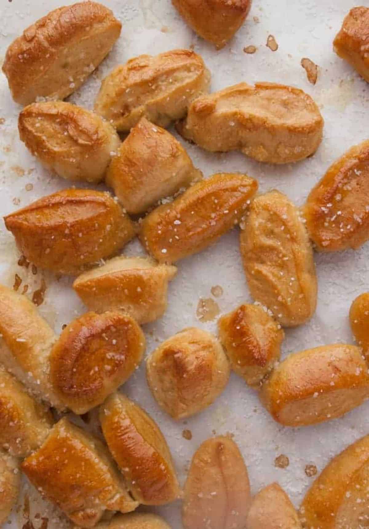 Crunchy Soft Pretzel Bites scattered on a table.