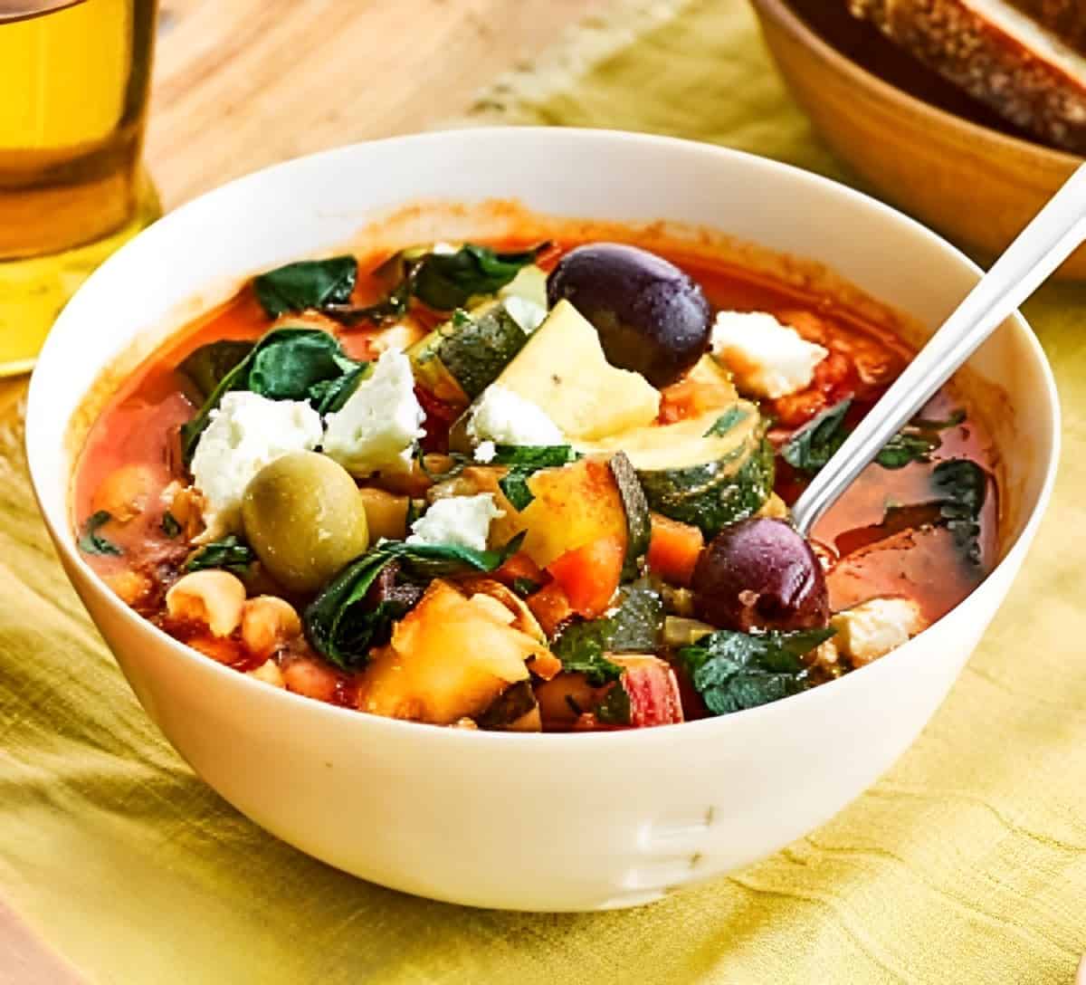 Fridge Raid Soup in a white bowl with a spoon.