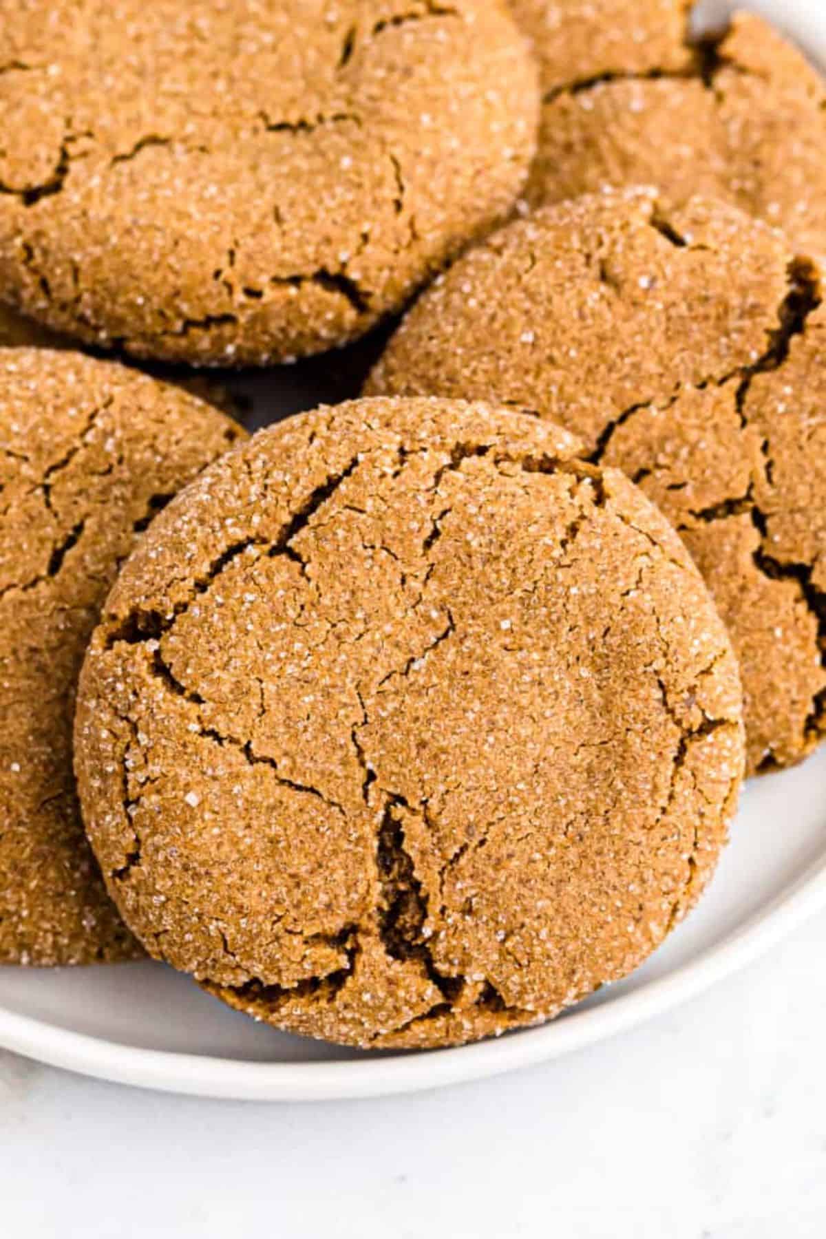 A bunch of Molasses Cookies on a white plate.