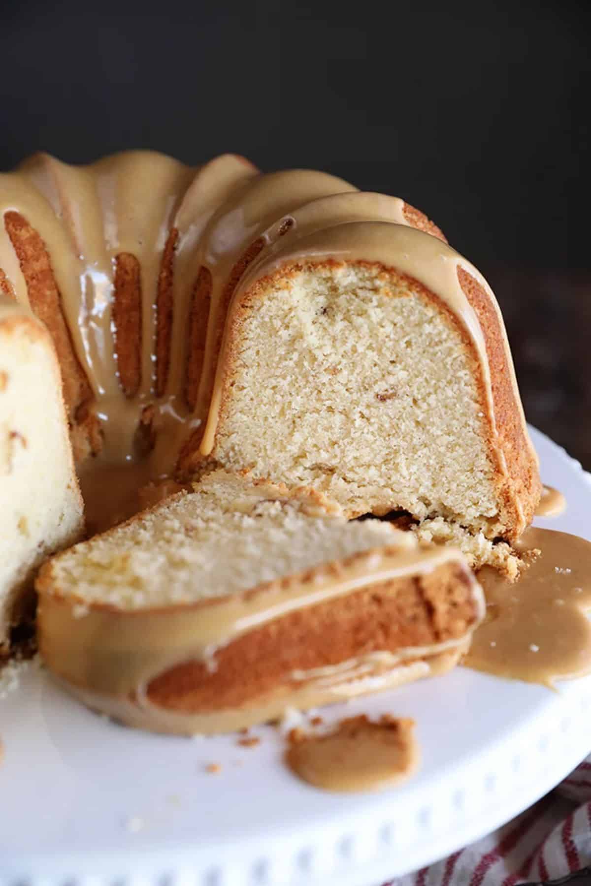 Partially sliced Peanut Butter Cream Pound Cake on a cake tray.