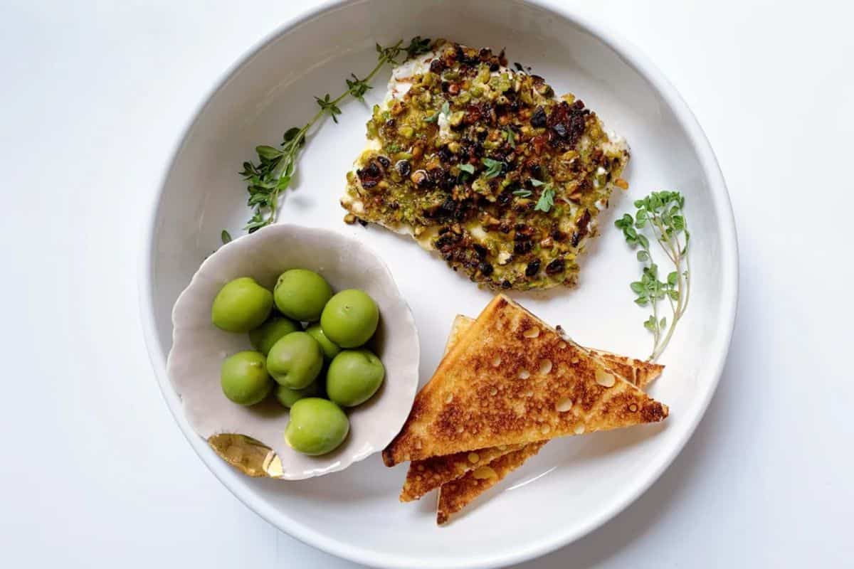Fried Feta With Pistachios on a white plate.