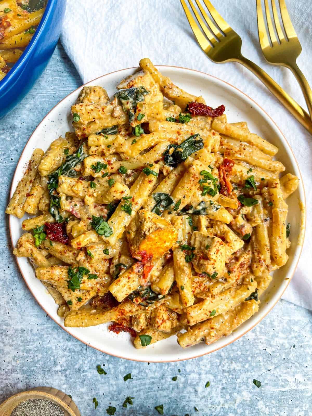 Creamy Sun-dried Tomato Pasta on a white plate.