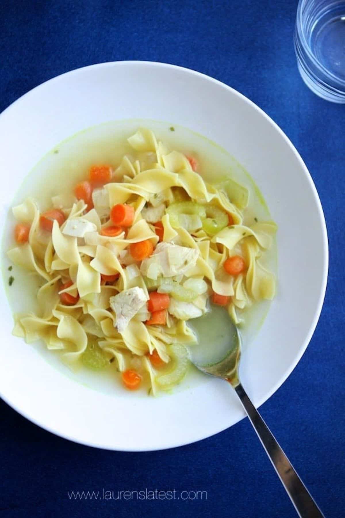 Delicious Classic Chicken Noodle Soup on a white plate.
