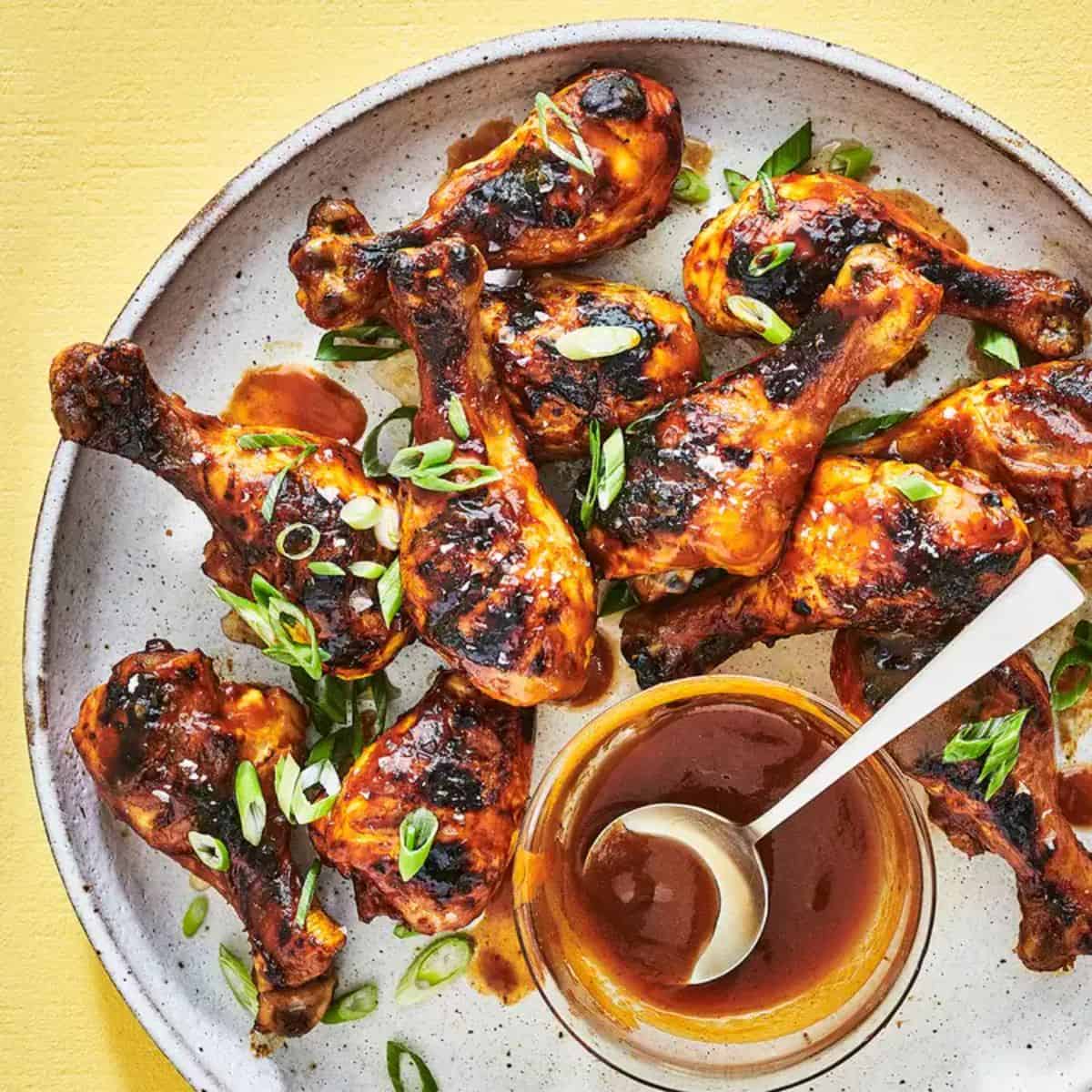 Mango-Ginger BBQ Chicken With Turmeric on a gray tray.