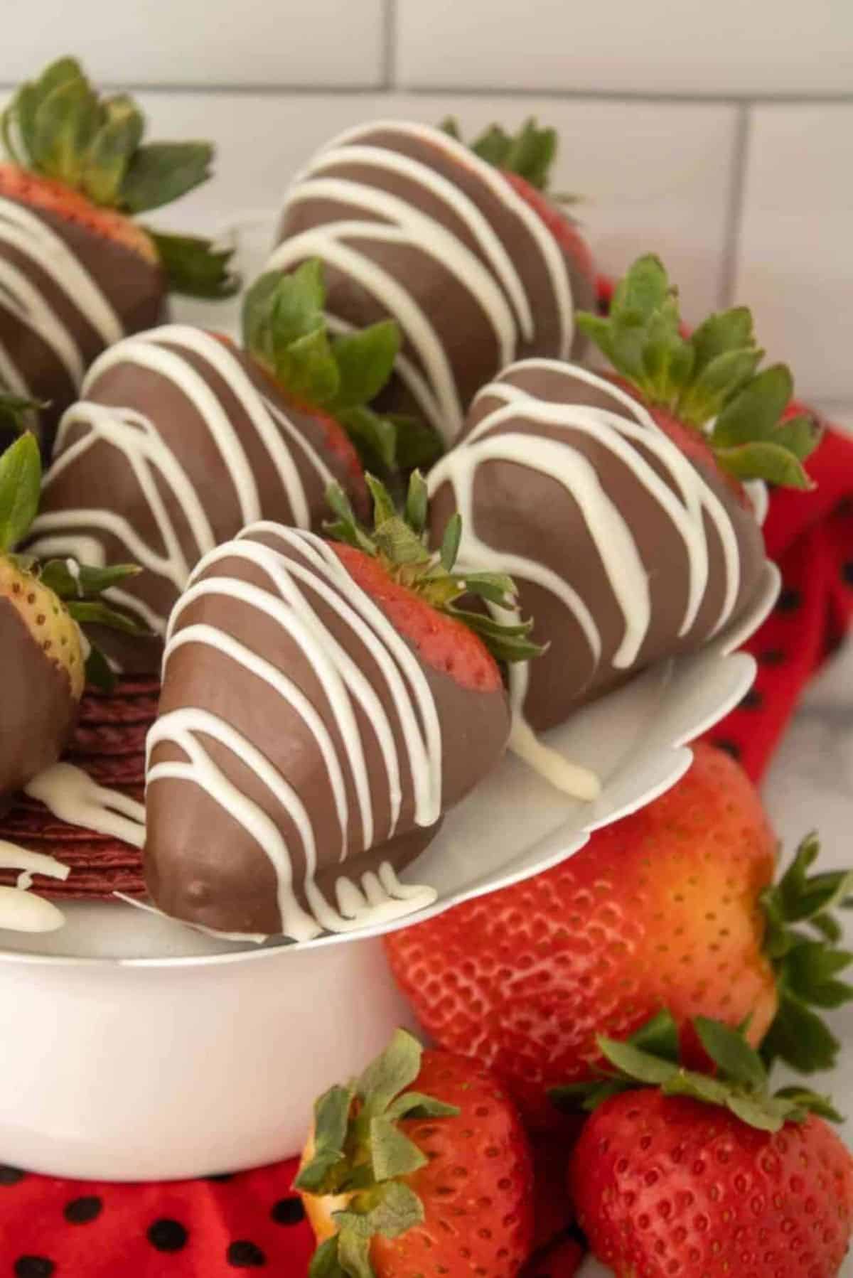 Easy Chocolate Covered Strawberries on a white cake tray.