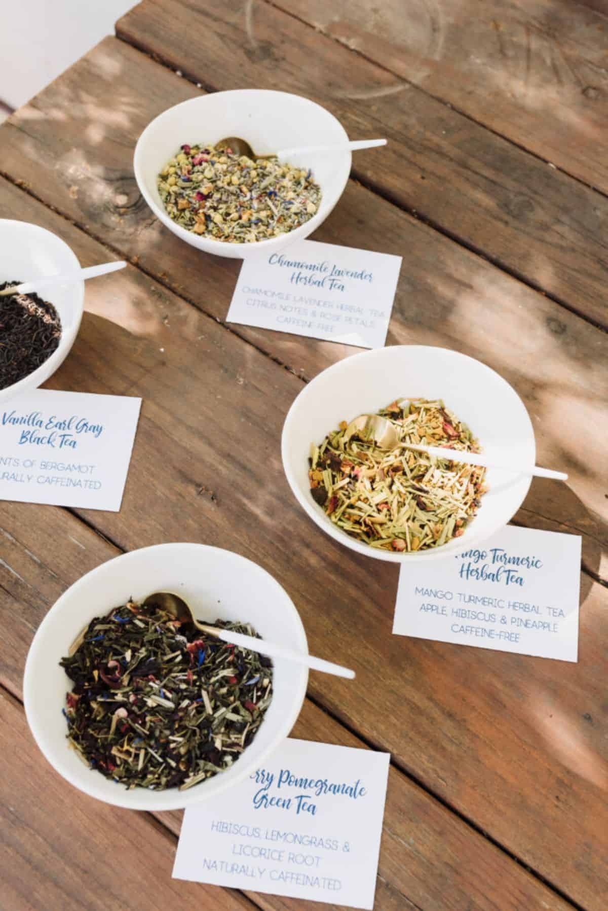 Different varieties of teas in white bowls.