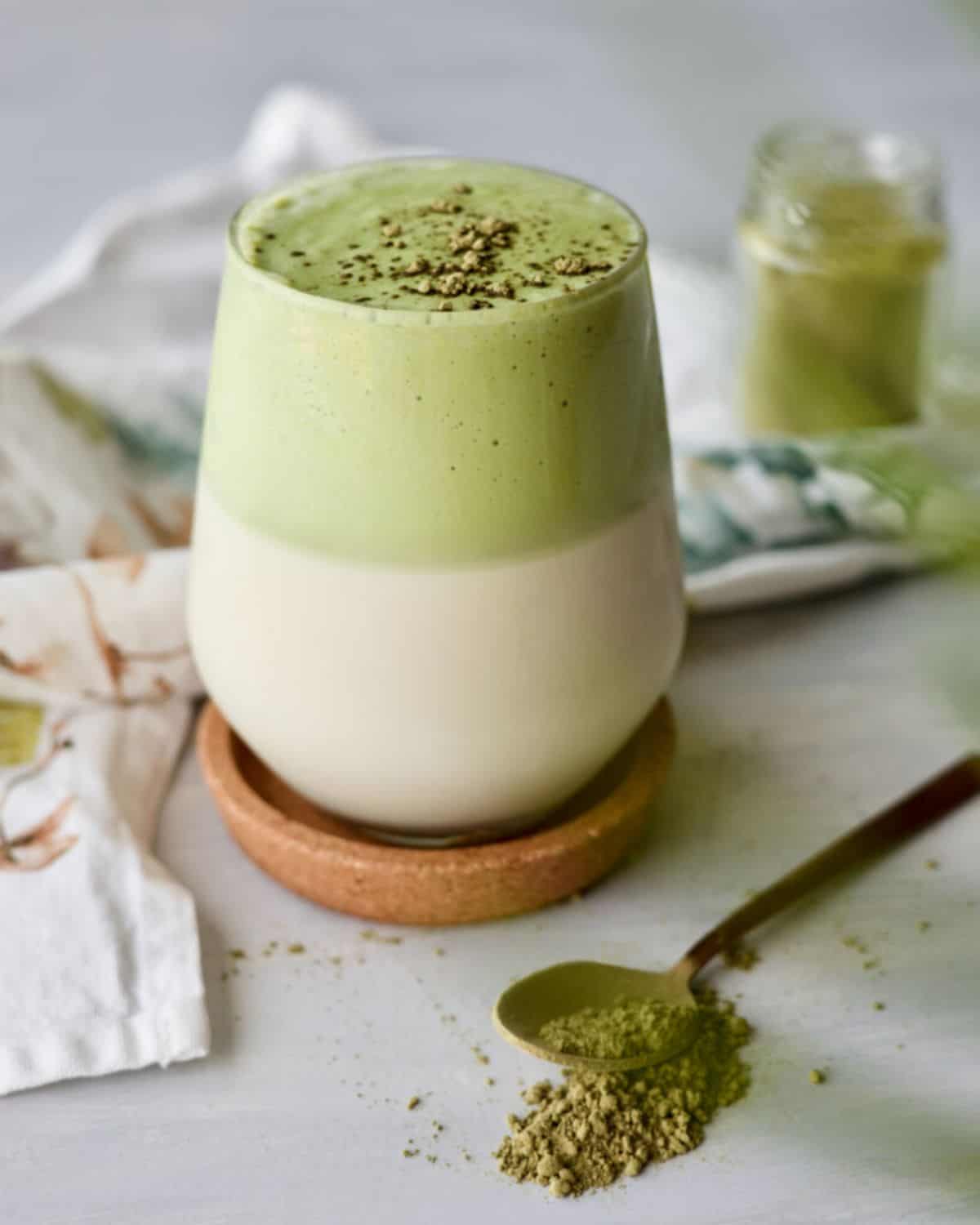 Matcha Coconut Dalgona Latte in a glass cup.