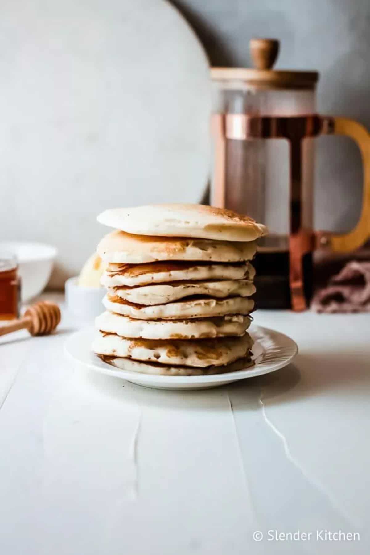 A stack of Greek Yogurt Pancakes on a white plate.