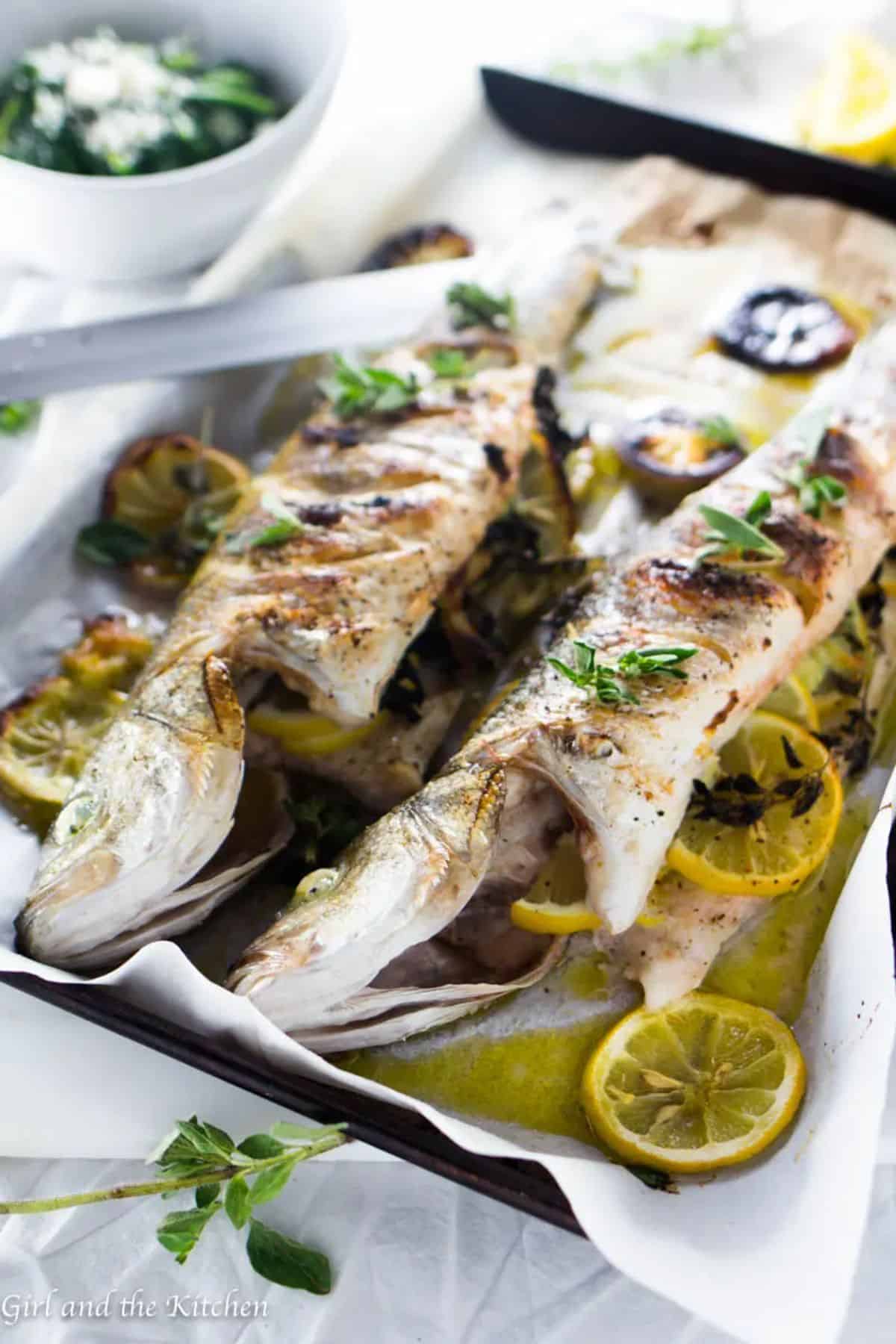 Roasted Branzino on a baking tray.