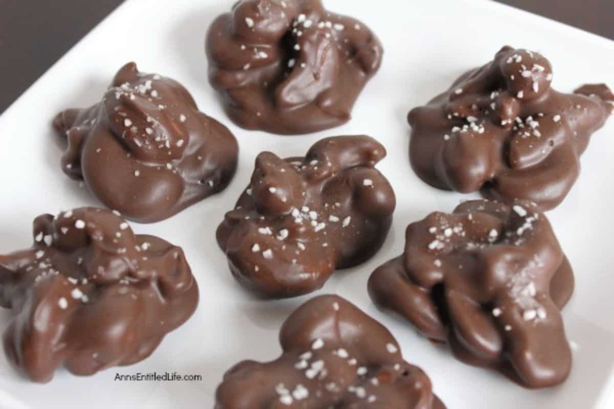 Chocolate Cashew Clusters on a white plate.