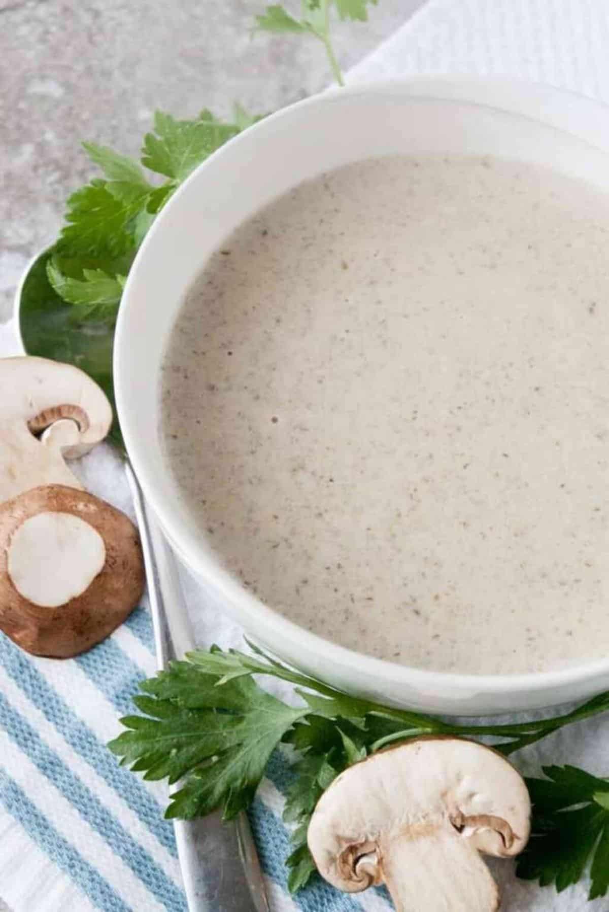 Delicious Creamy Mushroom Soup in a white bowl.