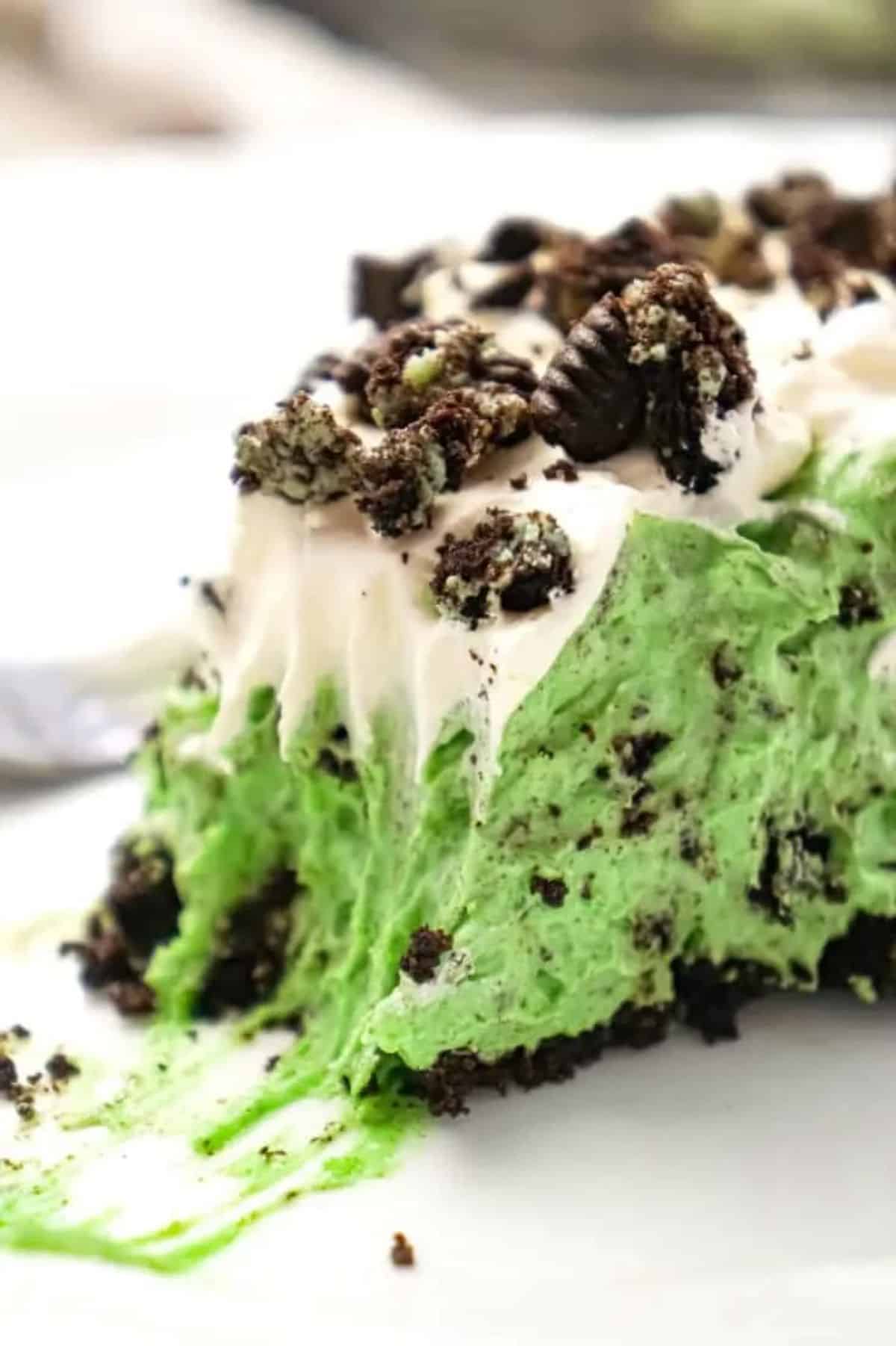 A piece of Mint Oreo Pie on a white plate.