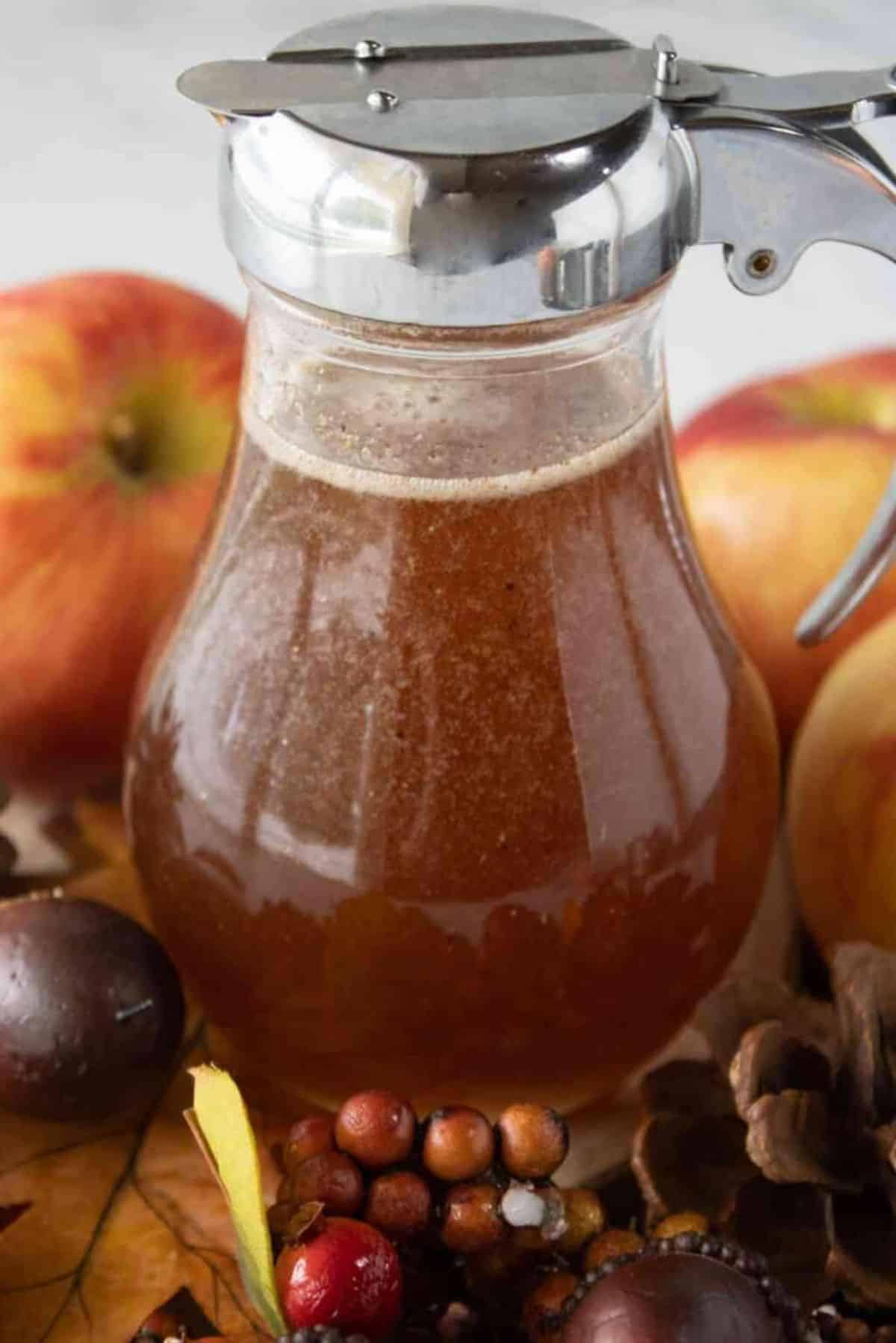 Easy Apple Cider Syrup in a glass pitcher.