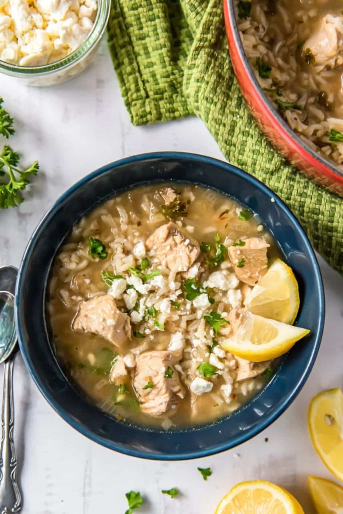 Greek Lemon Chicken Soup in a blue bowl.