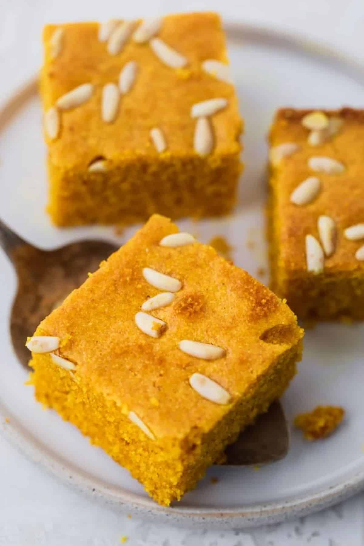 Three pieces of Turmeric Cake on a tray.