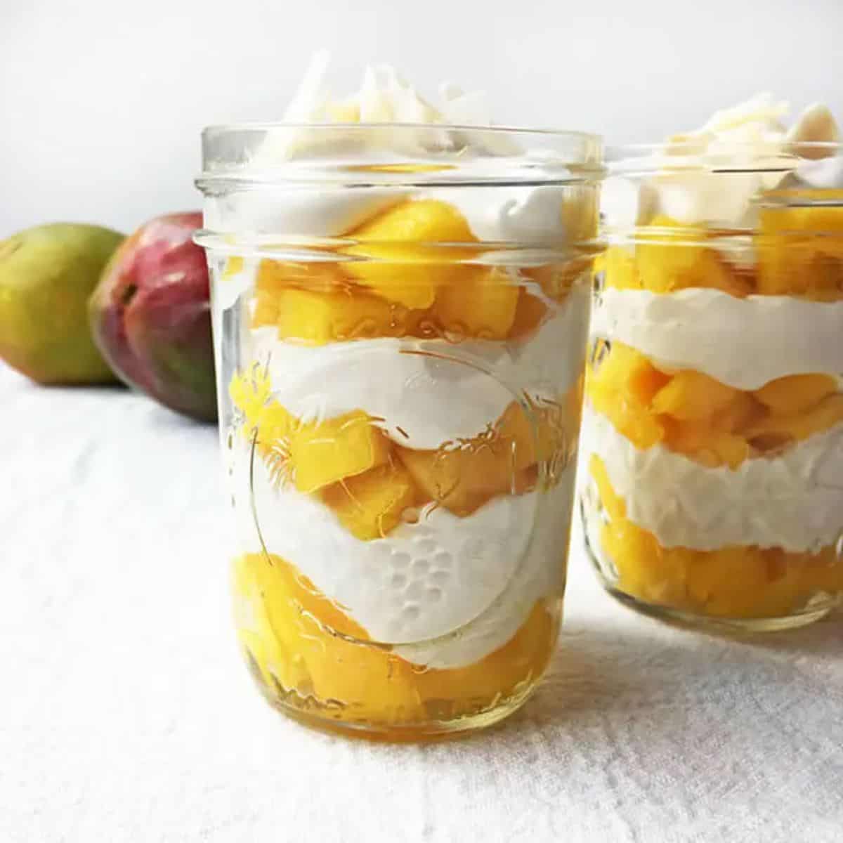 Coconut Mango Parfaits in glass jars.