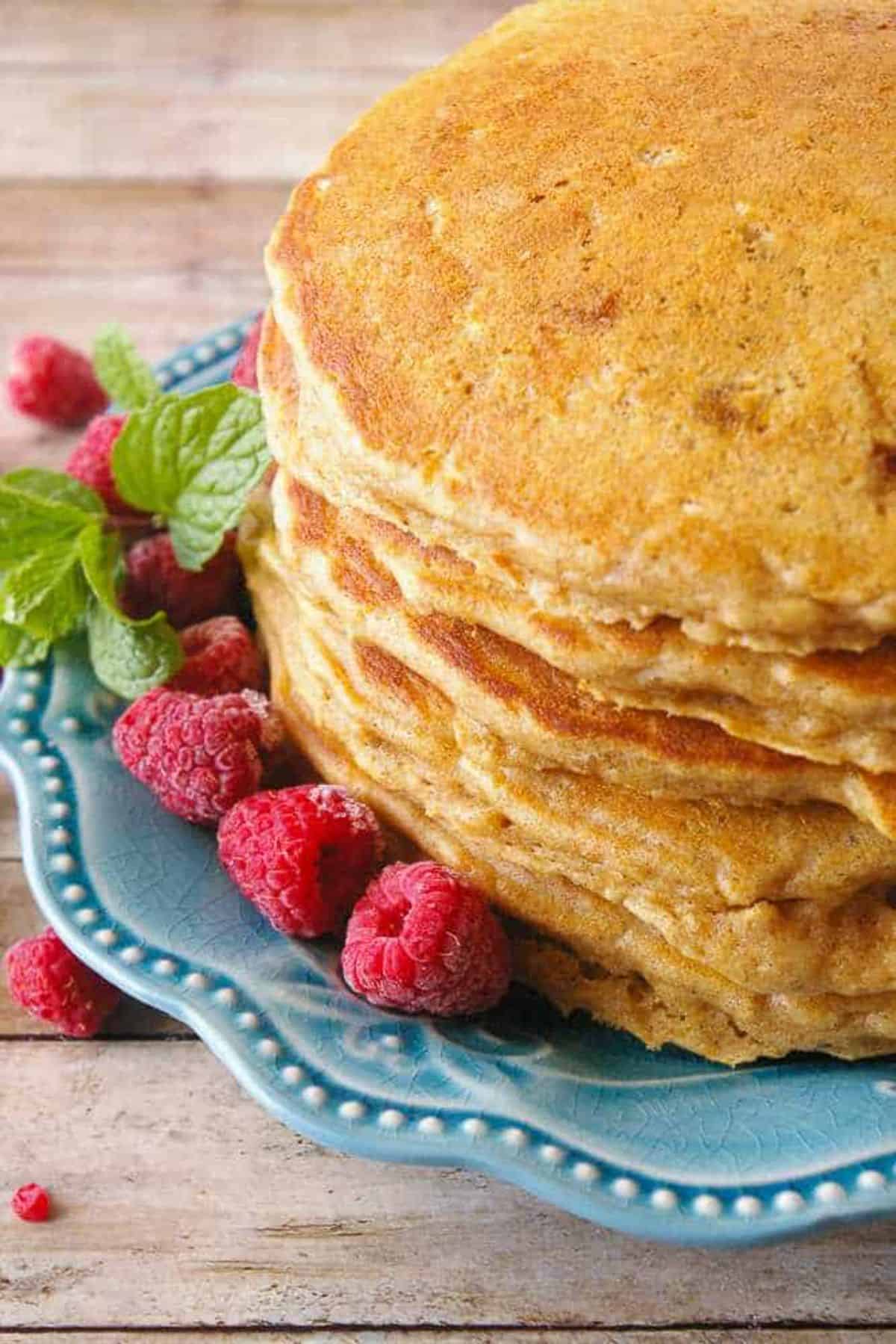 A stack of Whole Wheat Oatmeal Pancakes on a blue plate.