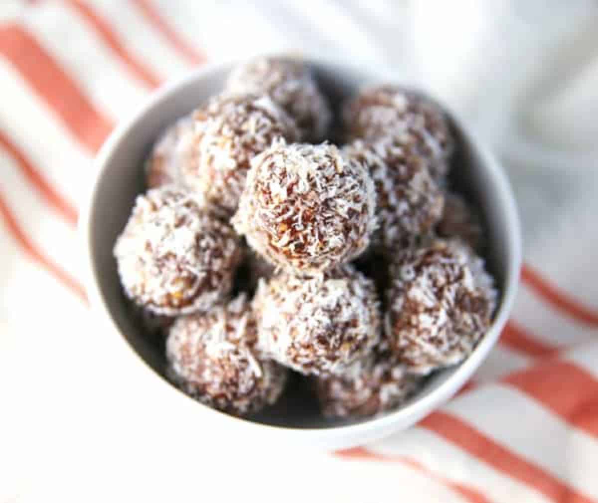 Coconut Cashew Date Balls in a small white bowl.