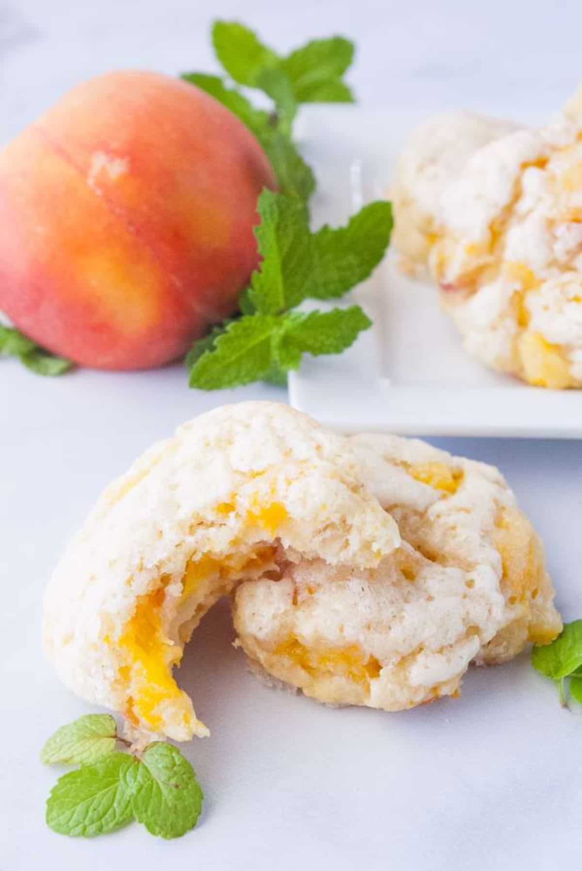 Peach Scones on a table with a ripe peach.